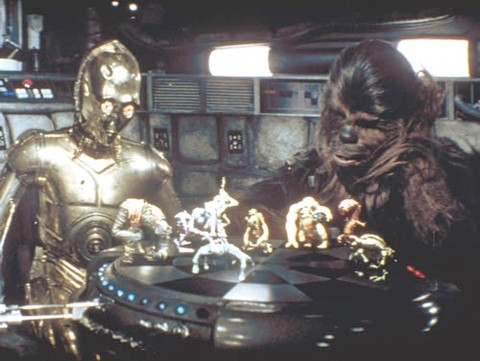 Star Wars has about a million gadgets I want, but the one that always sticks out the most is the holographic wrestling game on they have on the Millennium Falcon. All the little characters looked great, and the idea of a truly three-dimensional playing fi